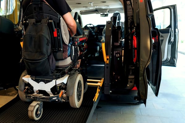Person in wheelchair boarding an accessible transport van